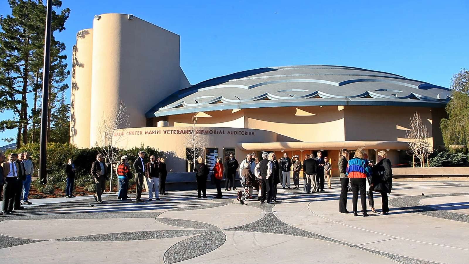 A crowd gathered on the forecourt plaza in front of the auditorium