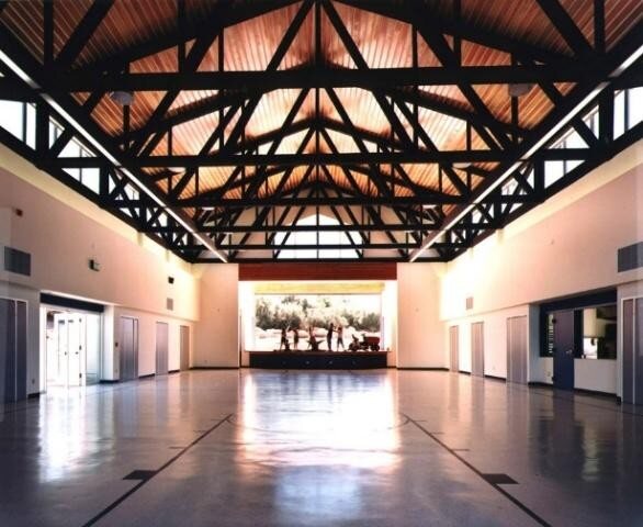 The multipurpose room with exposed roof trusses